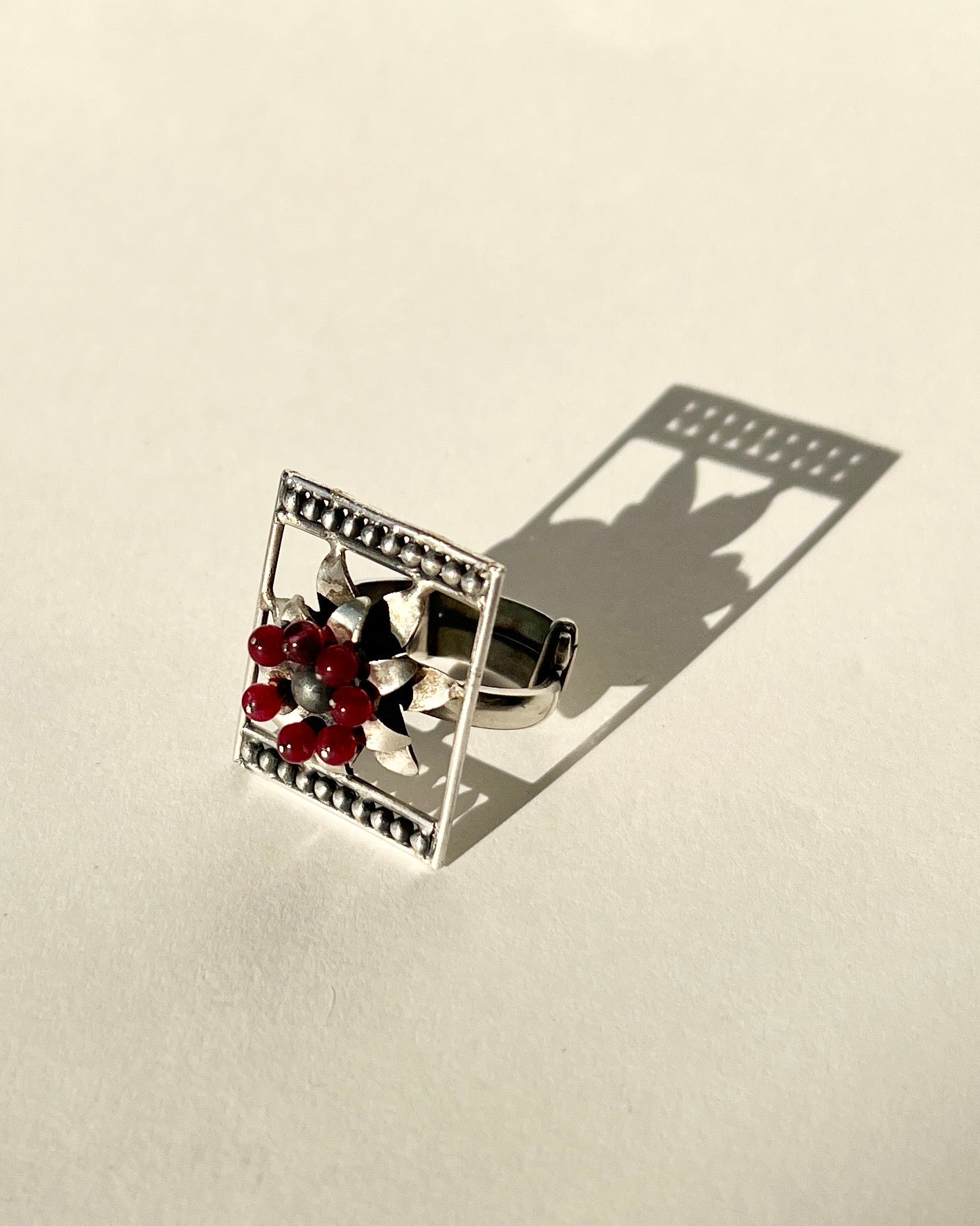 framed flower silver ring with garnet beaads