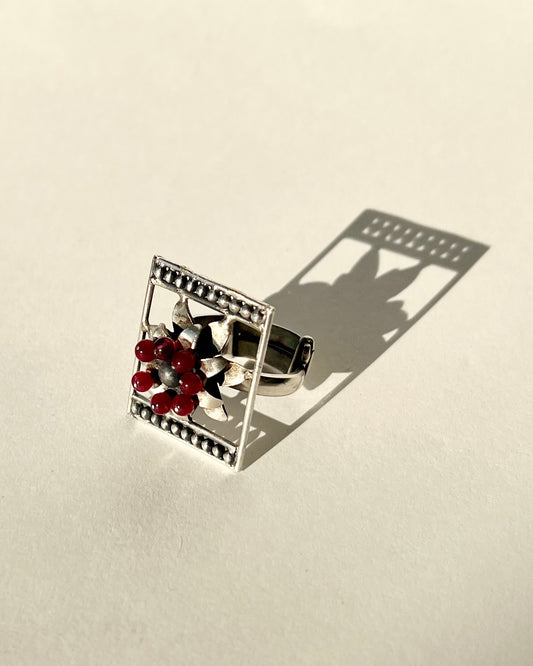 framed flower silver ring with garnet beaads