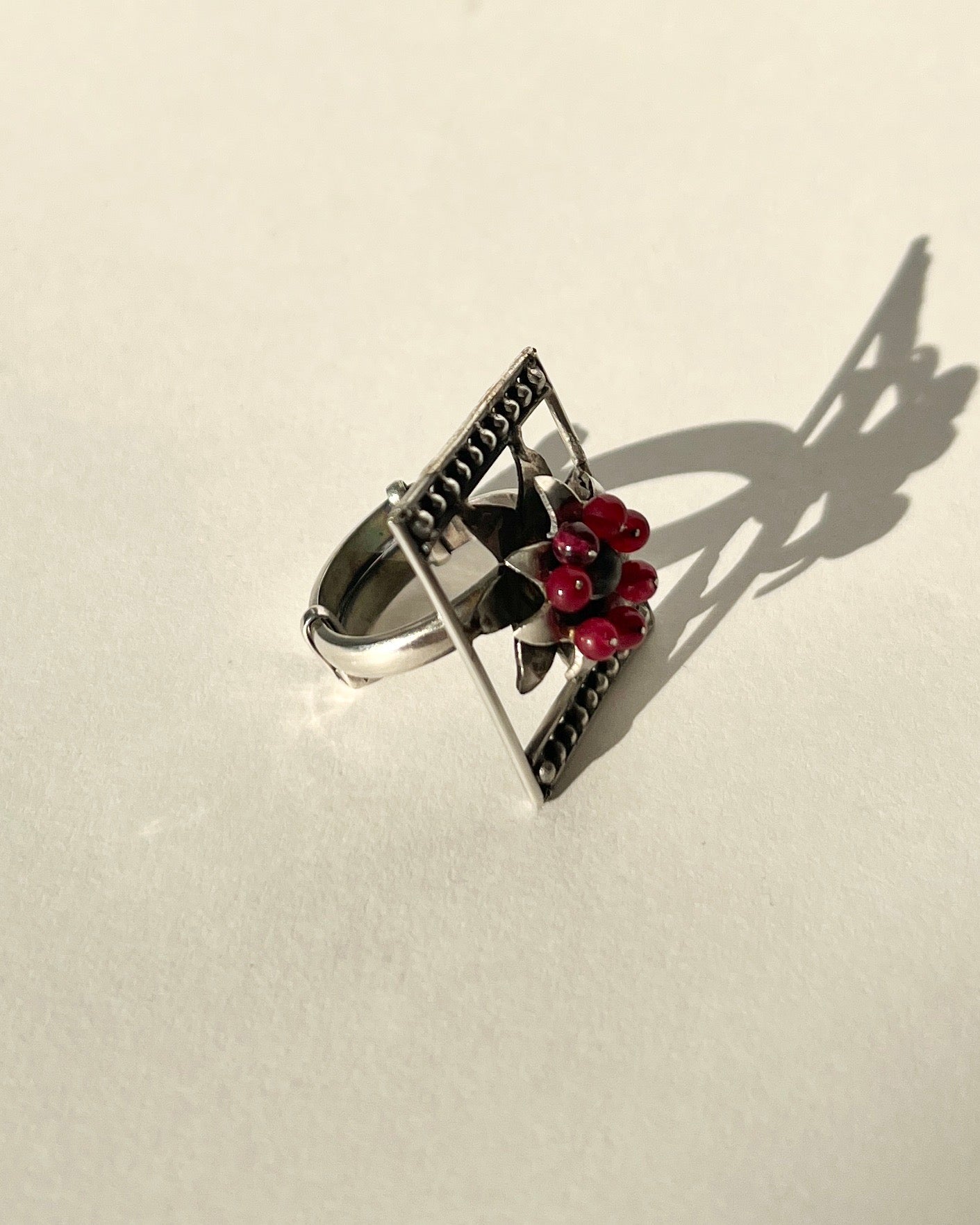 framed flower silver ring with garnet beaads