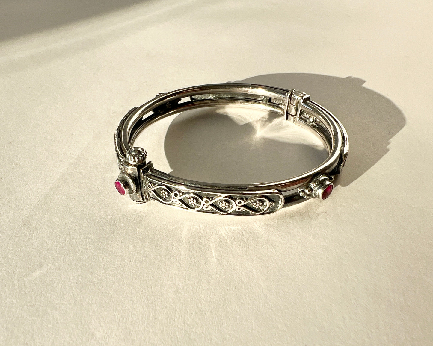 hinged floral bangle with rubies and pin closure