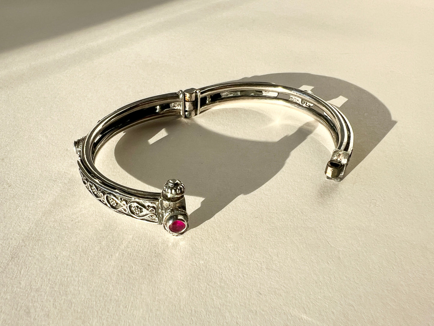 hinged floral bangle with rubies and pin closure