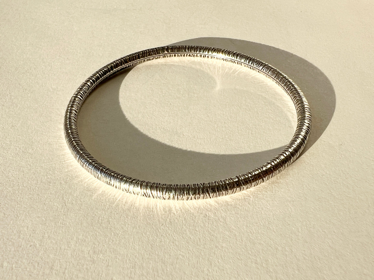 round silver bangles with tension closure