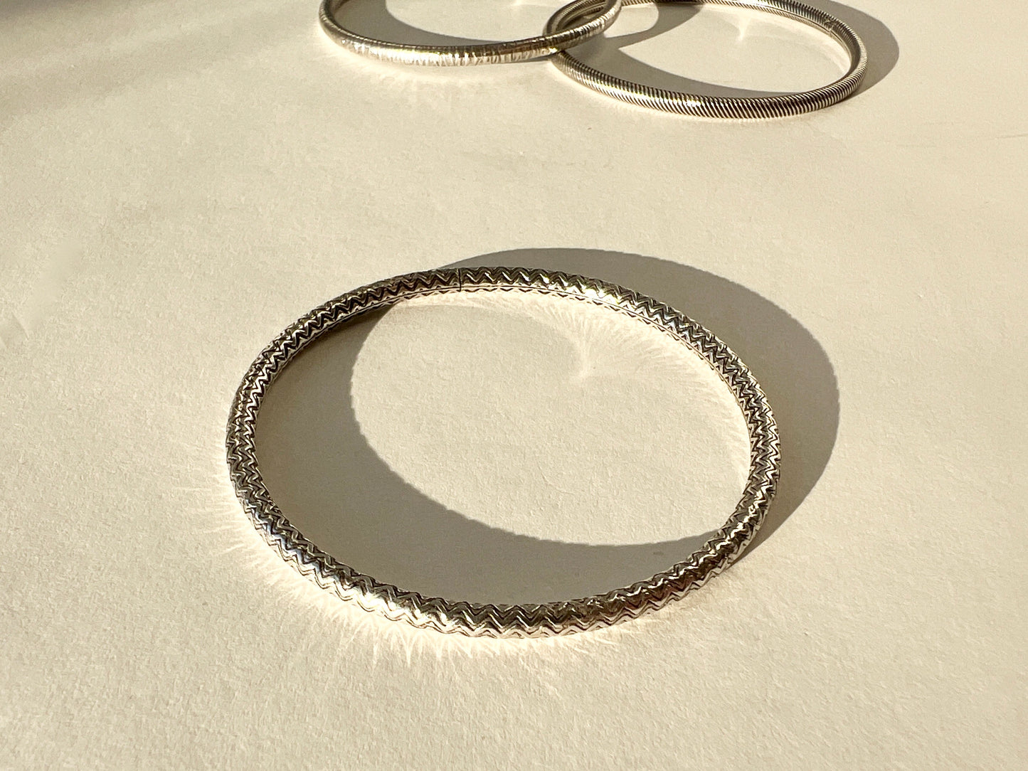 round silver bangles with tension closure