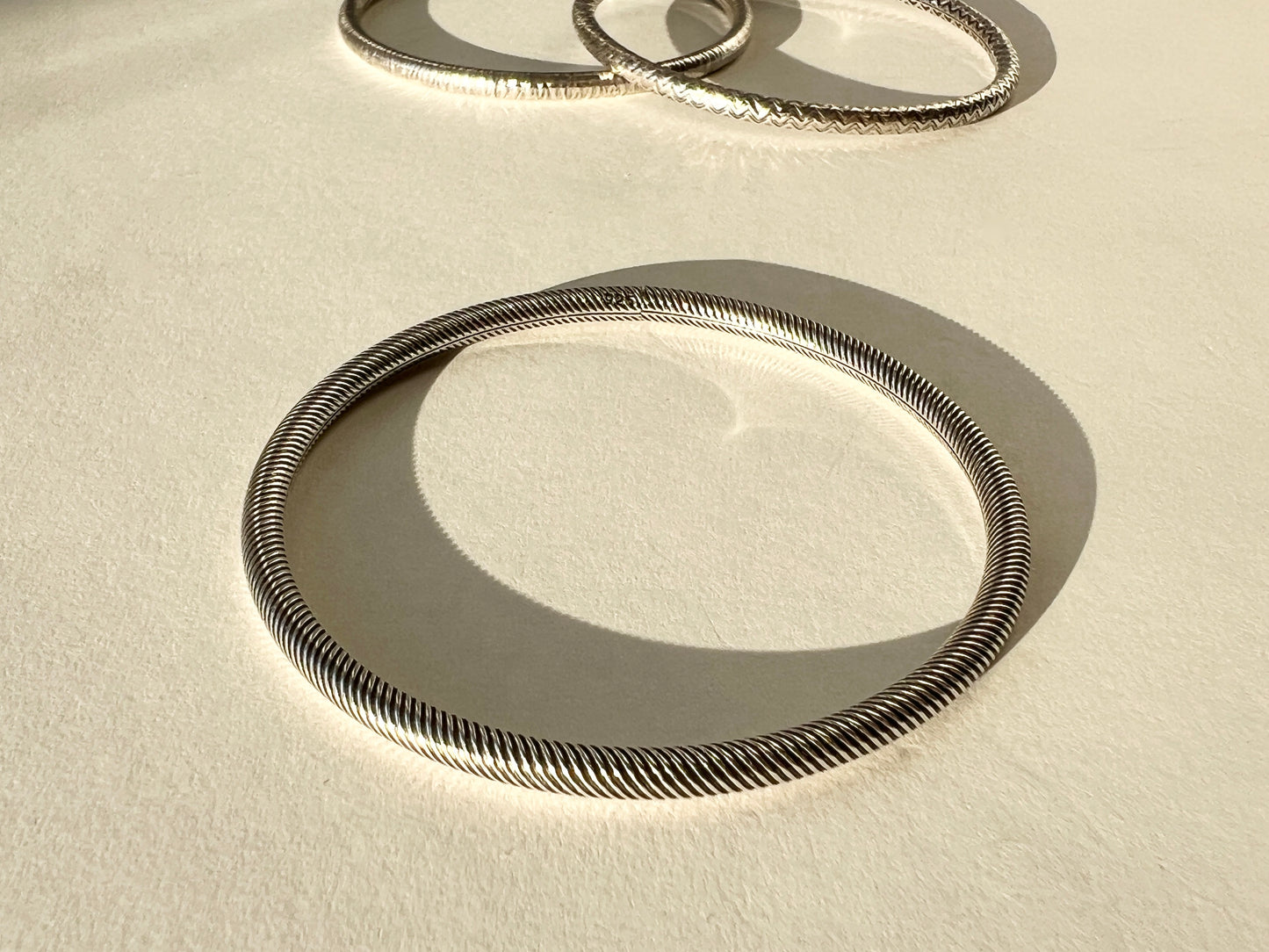 round silver bangles with tension closure