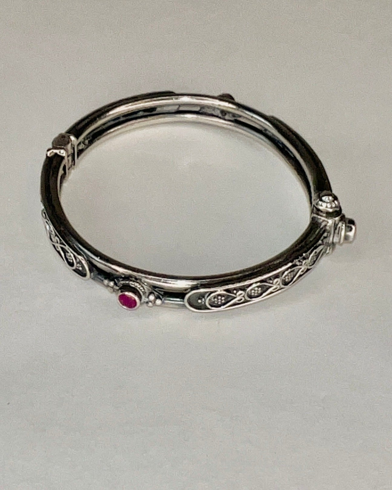 hinged floral bangle with rubies and pin closure