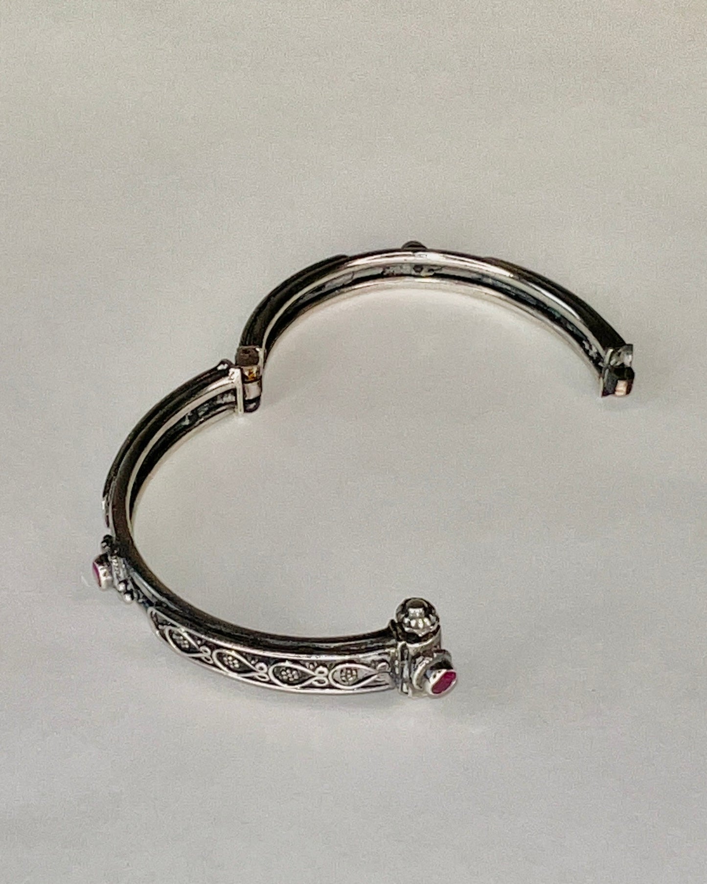 hinged floral bangle with rubies and pin closure