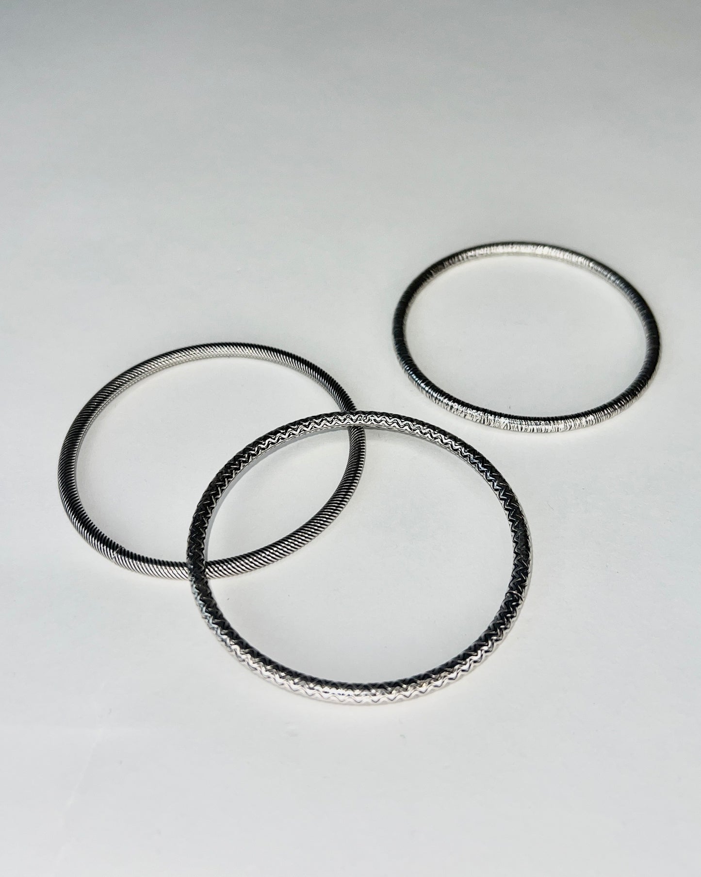 round silver bangles with tension closure