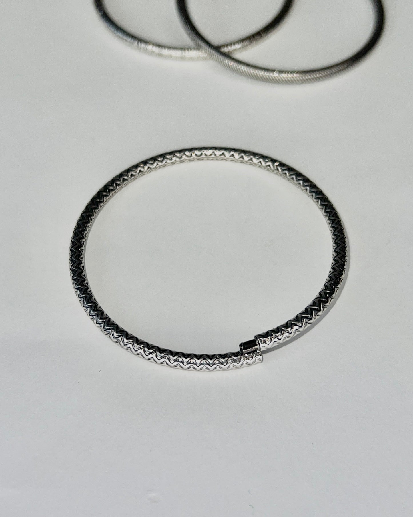 round silver bangles with tension closure