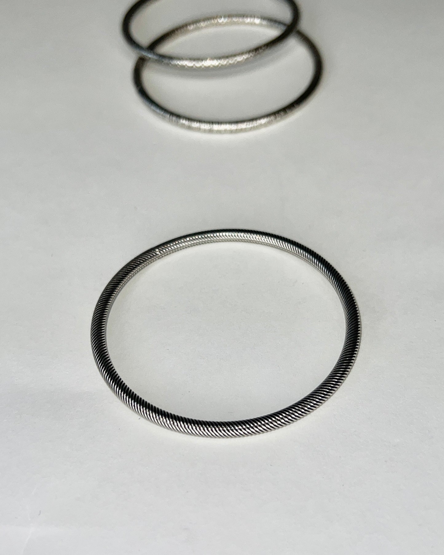 round silver bangles with tension closure