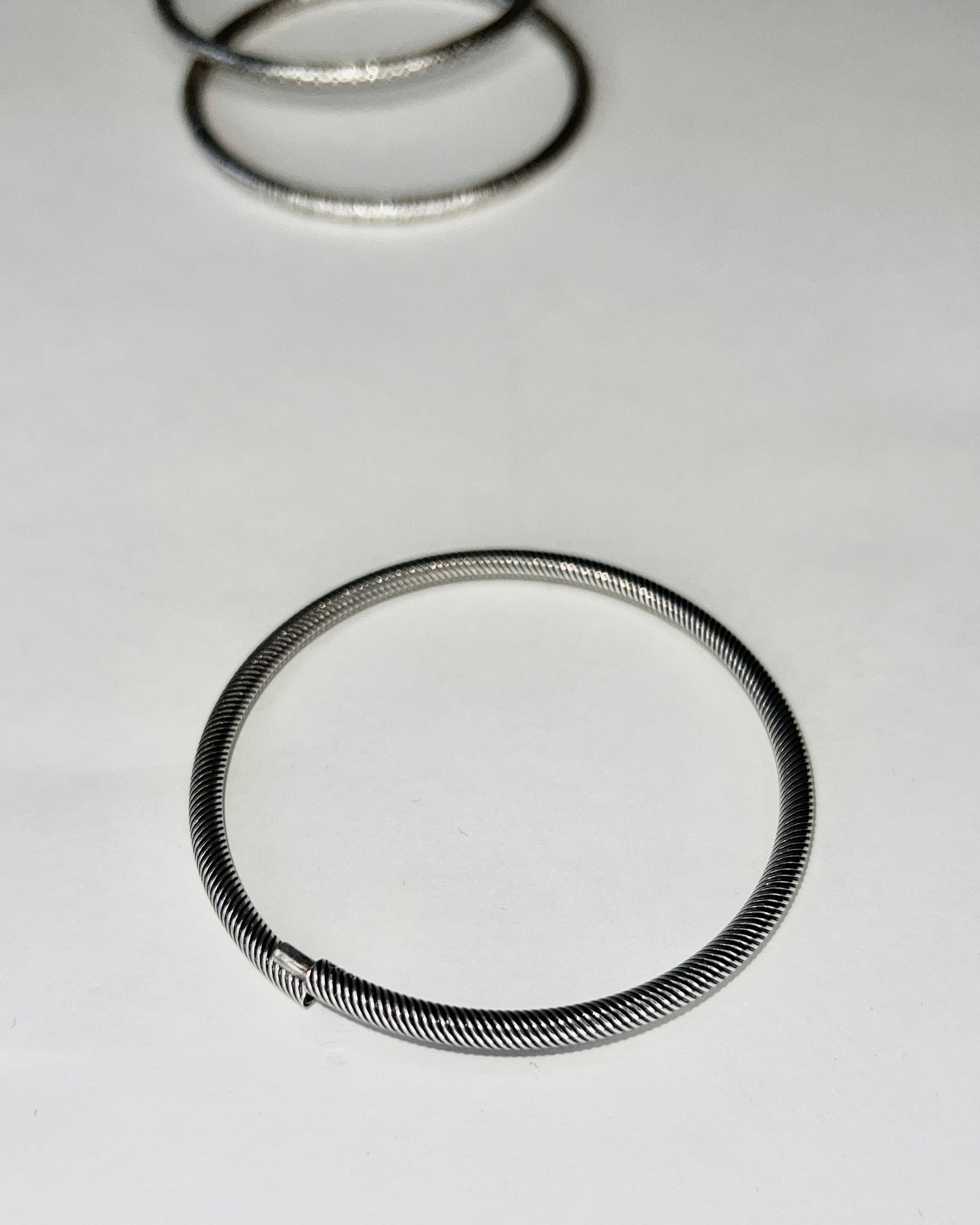 round silver bangles with tension closure