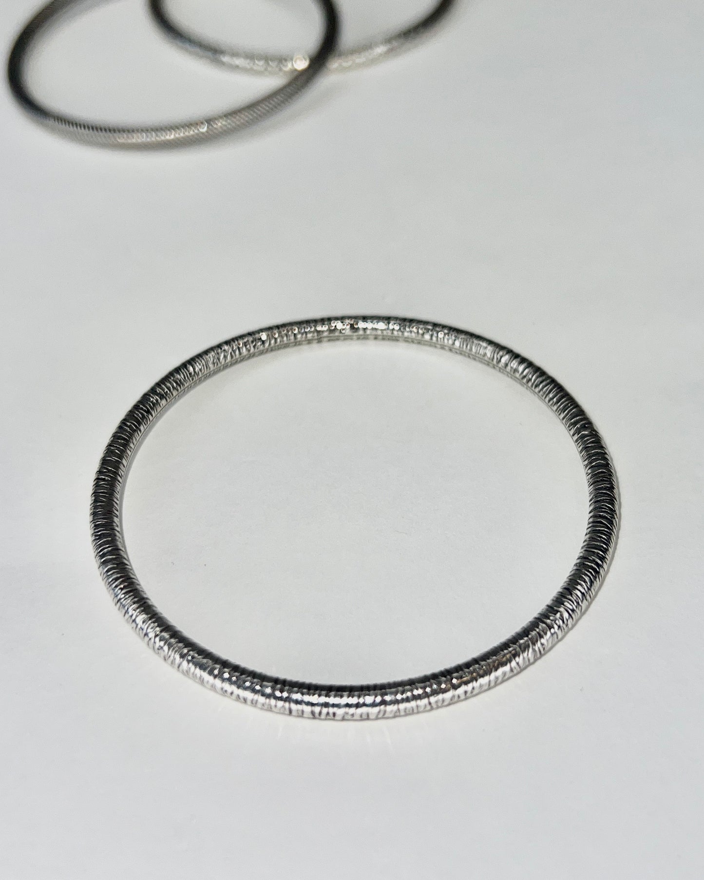 round silver bangles with tension closure