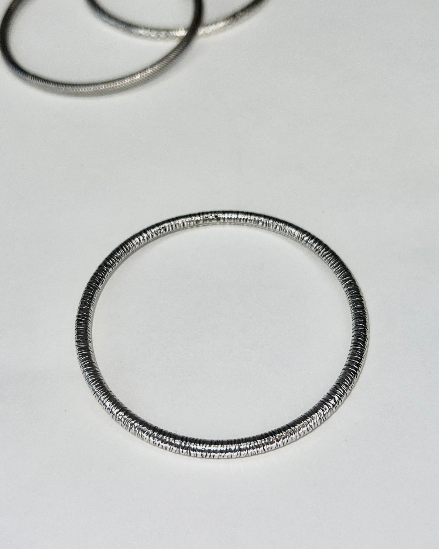 round silver bangles with tension closure