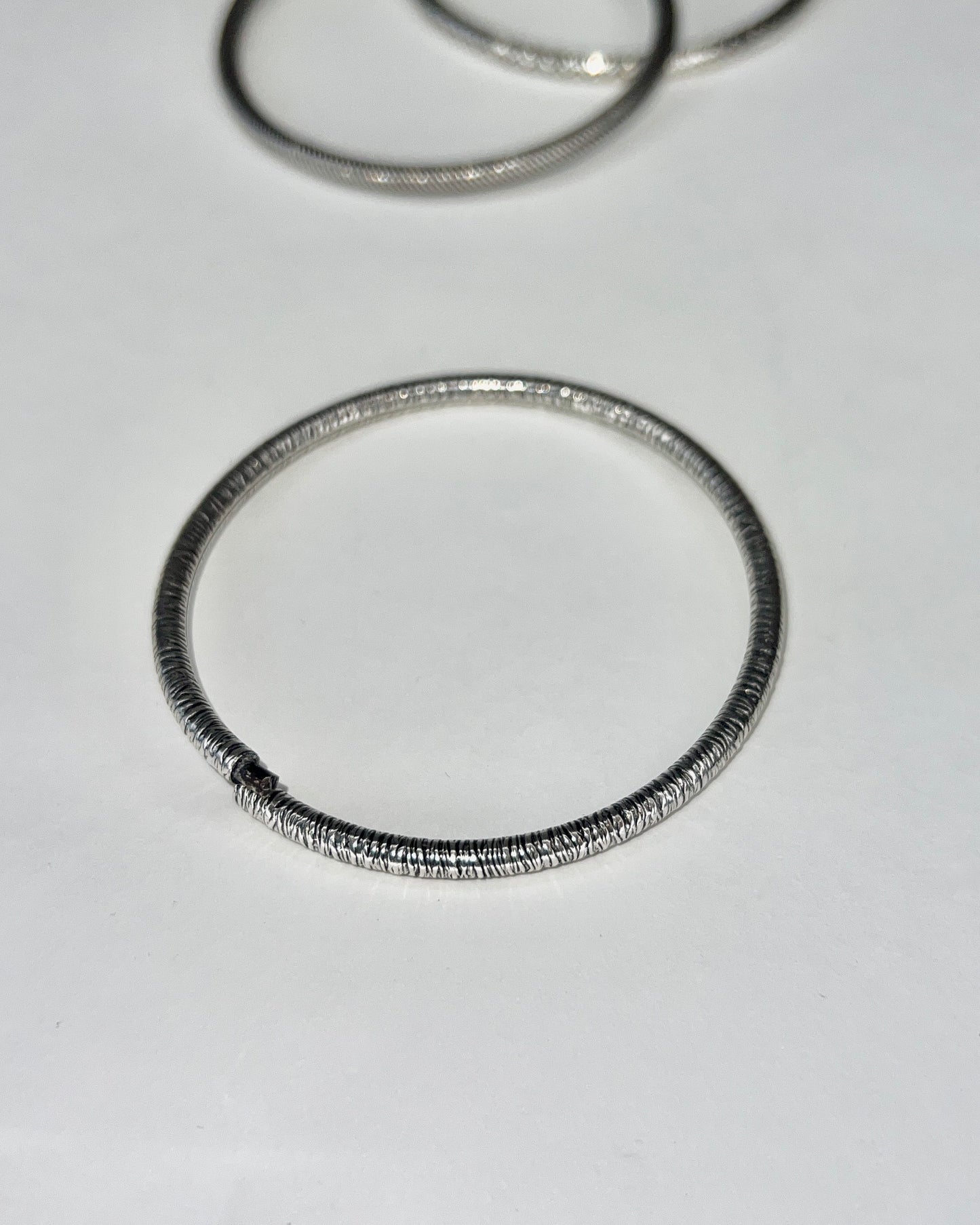 round silver bangles with tension closure