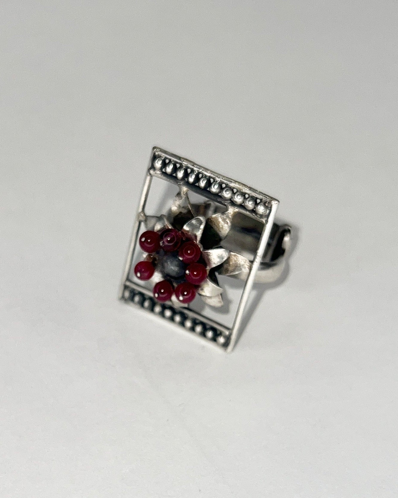 framed flower silver ring with garnet beaads